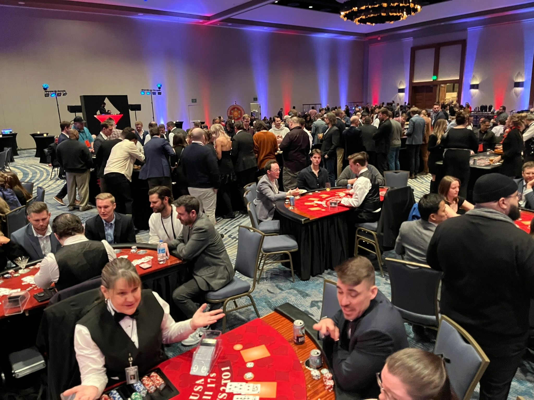 Casino event in a large ballroom with guests at gaming tables